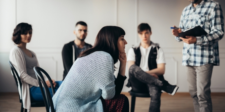 Woman with ADHD in addiction recovery group therapy