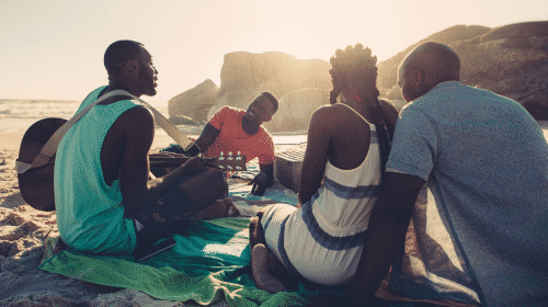 group of african american friends at beach
