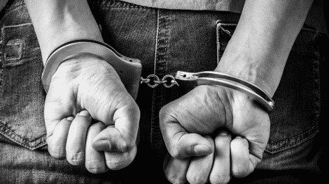 hand cuffs on hands illicit drug arrest