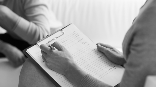 female therapist writing down notes