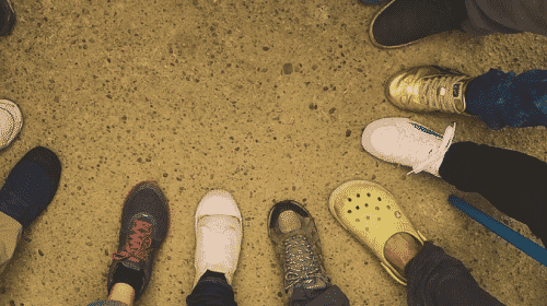 group of people with feet in circle