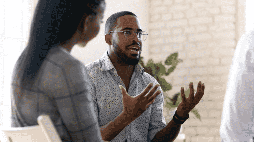 man talking with group