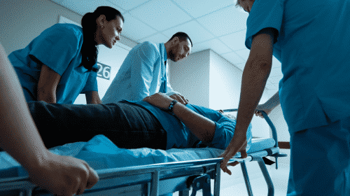 hospital staff taking man on gurney