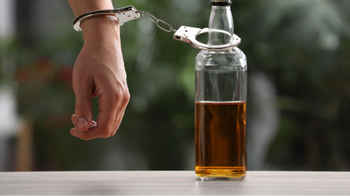 man handcuffed to alcohol