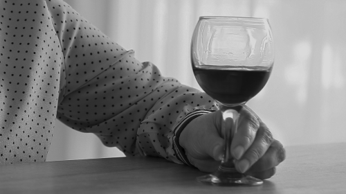 woman holding glass of wine