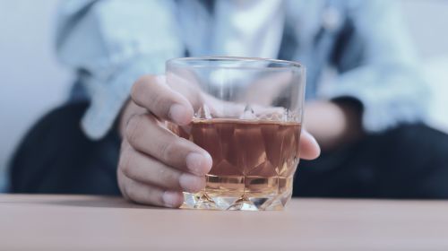 man with glass of hard liquor