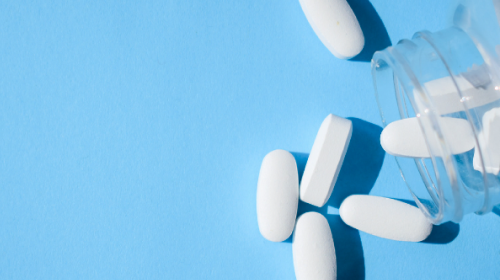 opioid tablets on blue background