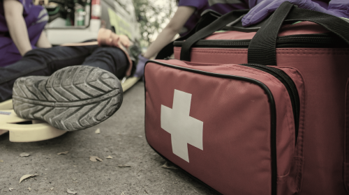 emt helping man on ground