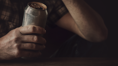male holding can of beer