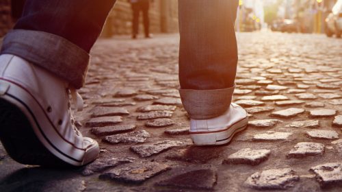 man walking on road