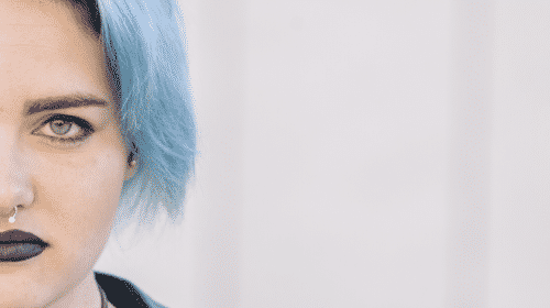 serious woman with blue hair