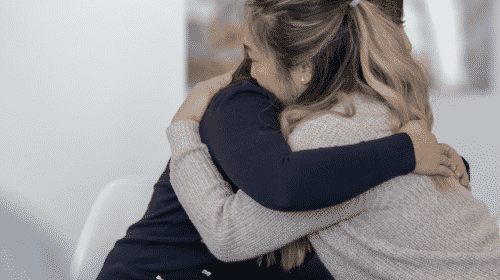 two woman hugging