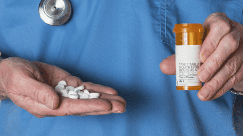 doctors hands holding opioids