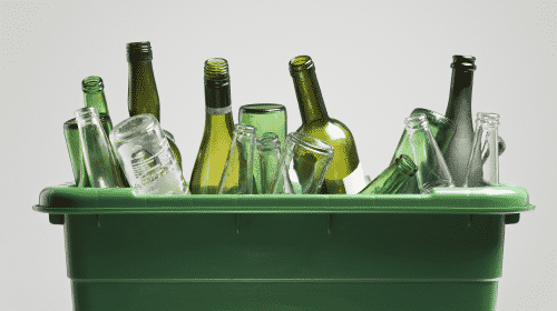 green bucket of empty alcohol bottles