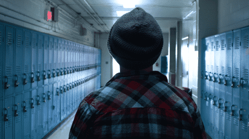 high school student in middle of hallway