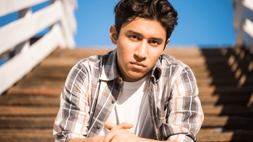 teenage young man sitting on stairs