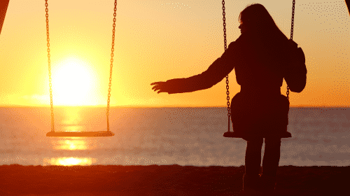 woman on swing next to empty swing