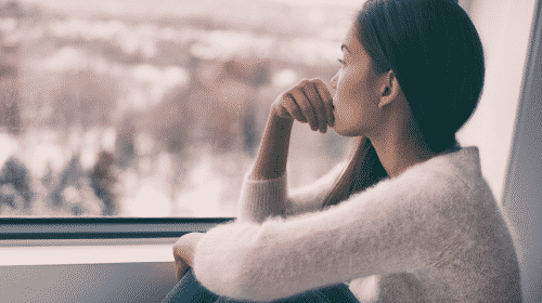 woman staring out of window