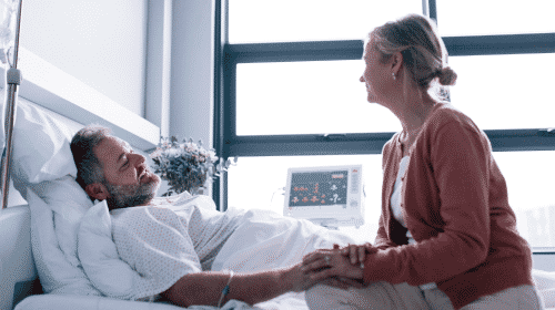 woman visiting man in hospital