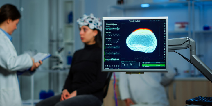 A neurologist running tests on a patient and analyzing their brain