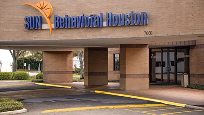 Modern brick building with a welcoming canopy, marking the entrance to Sun Behavioral Houston.