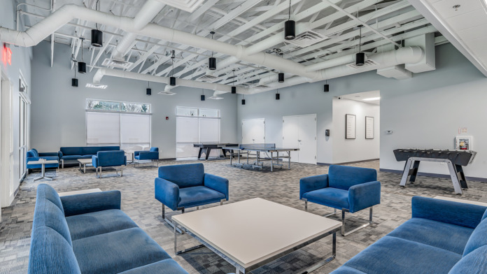 Activity and rec roam at boca recovery huntington indiana with blue couches, ping pong table, and Foosball table