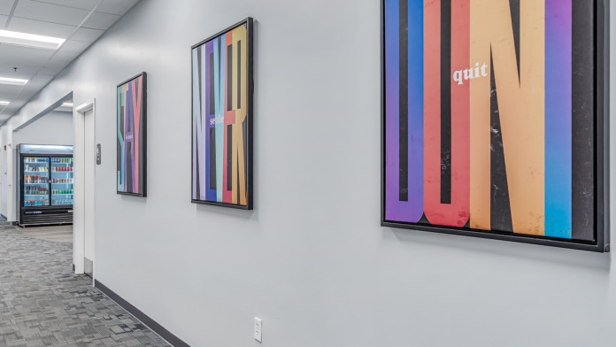 Hall way with motivational art, and a drink fridge at boca recovery in huntington indiana