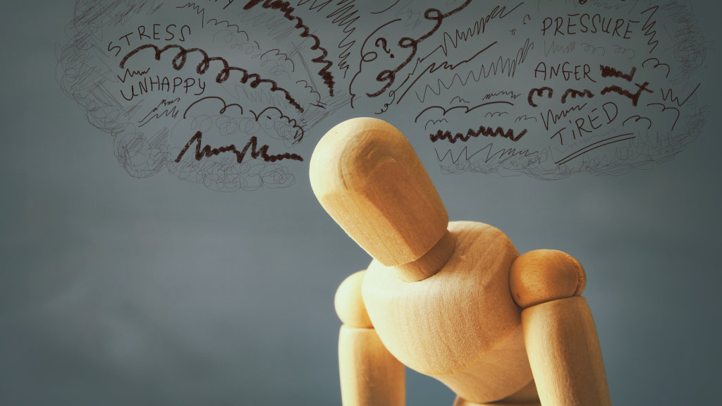 A mannequin with scribbles near it's head, suggesting anxiety or mental fatigue