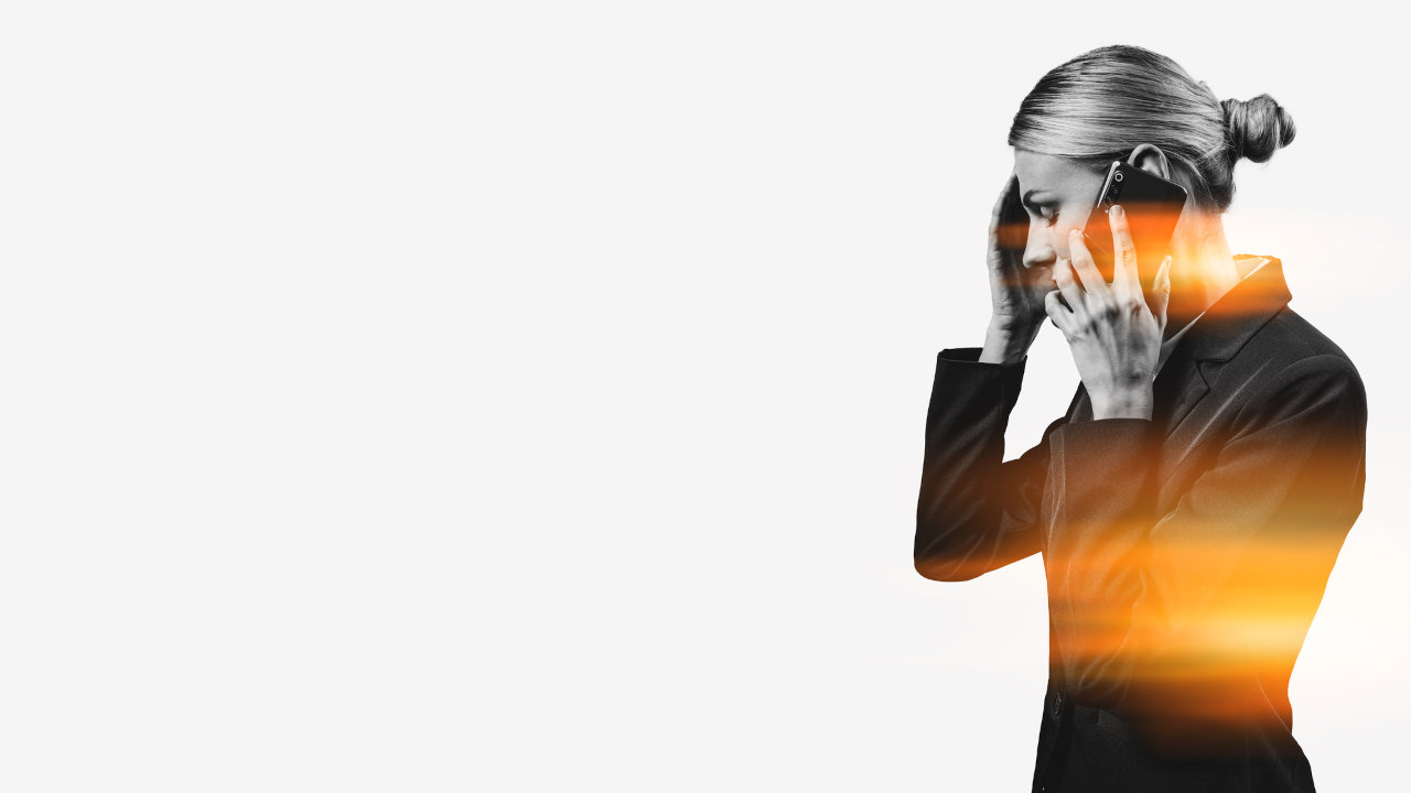 A woman grips her forehead, suggesting she's suffering from a headache or other withdrawal symptoms.