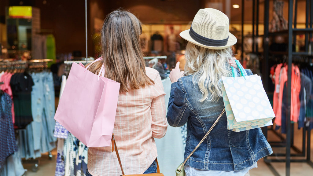 Two people with shopping bags, shopping around at the mall