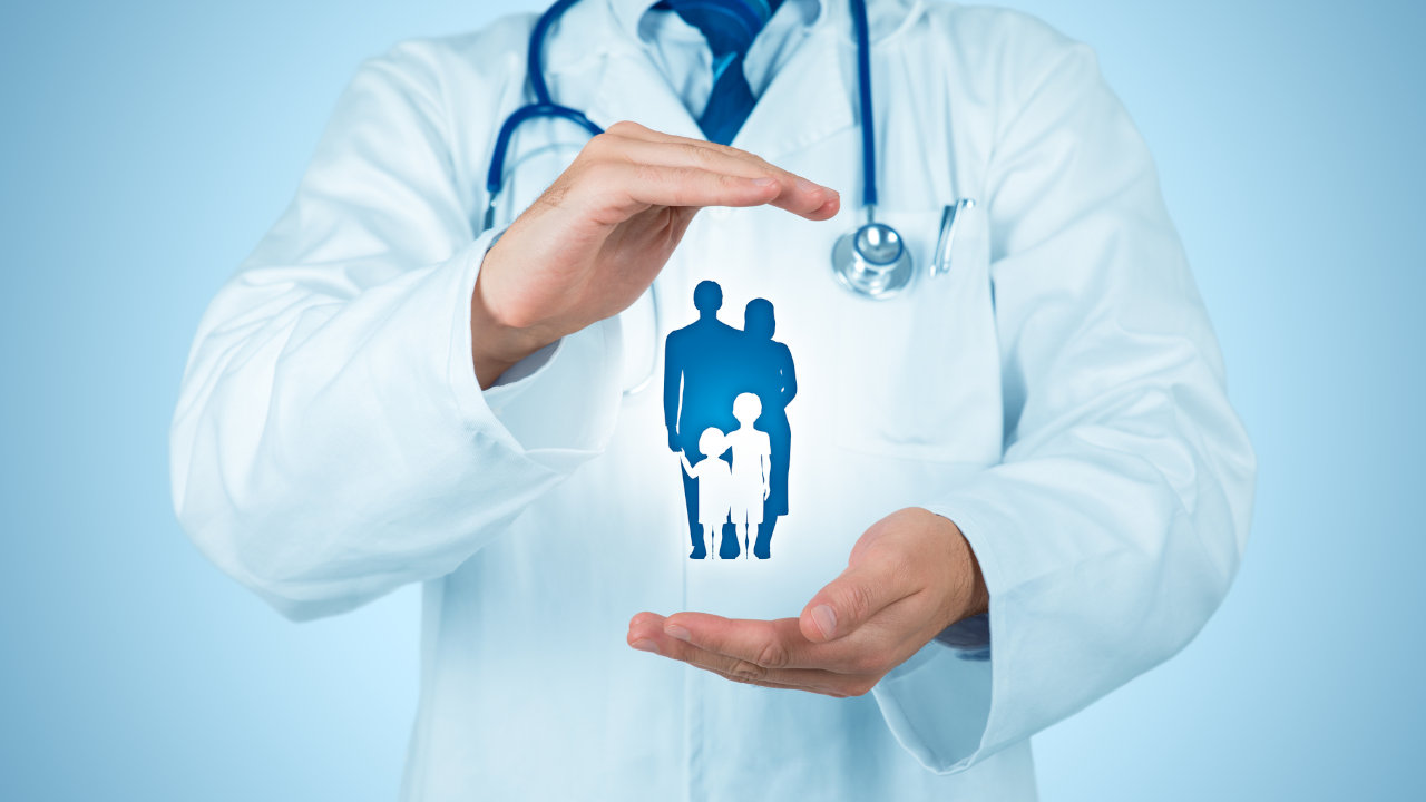 A doctor holding an image of a family, referencing family health insurance