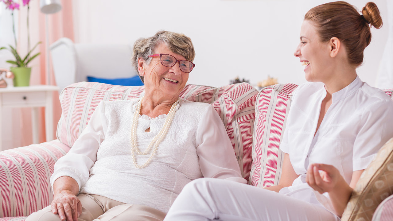 A woman in a recovery facility speaks with a nurse