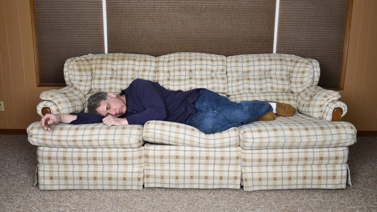 a man passed out on a couch, possibly under the influence of cannabis use disorder