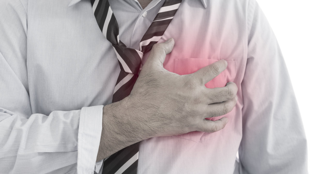 A man clutches his chest in pain as he's struck with a heart attack, a common symptom of cocaine overdose
