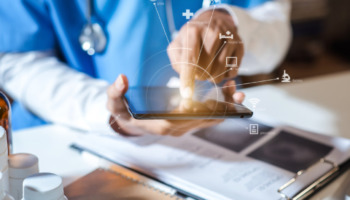 A doctor pressing a tablet, referencing telehealth support. Telehealth can be a great source for outpatient drug addiction support