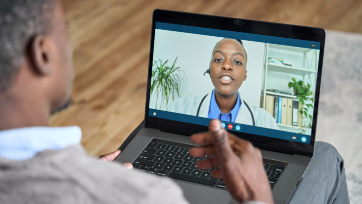 A man speaks with a doctor during a telehealth session