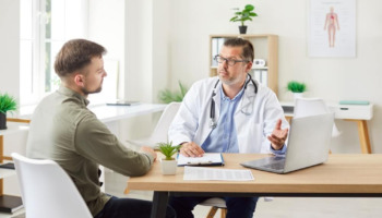 A man speaking with a doctor. Learn more about buprenorphine vs methadone, including the differences and effectiveness between the two.