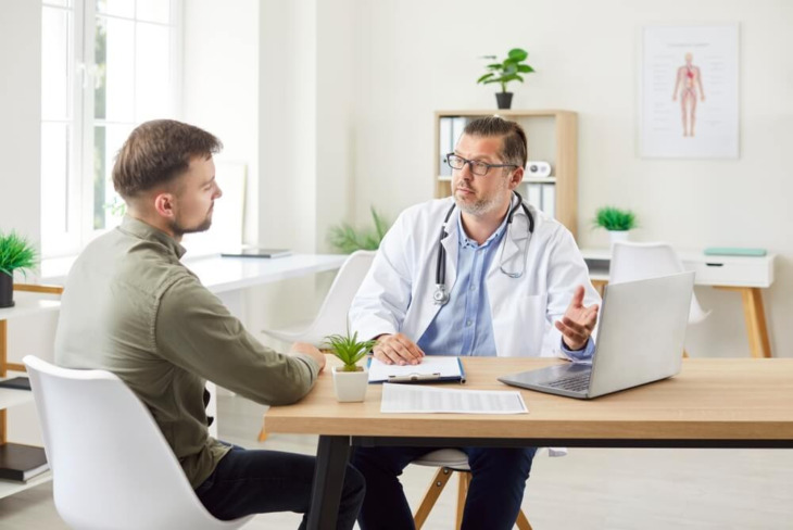 A man speaking with a doctor. Learn more about buprenorphine vs methadone, including the differences and effectiveness between the two.