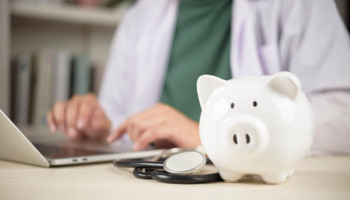 A doctor with a piggy bank. Learn more about if medicaid covers addiction rehab here.