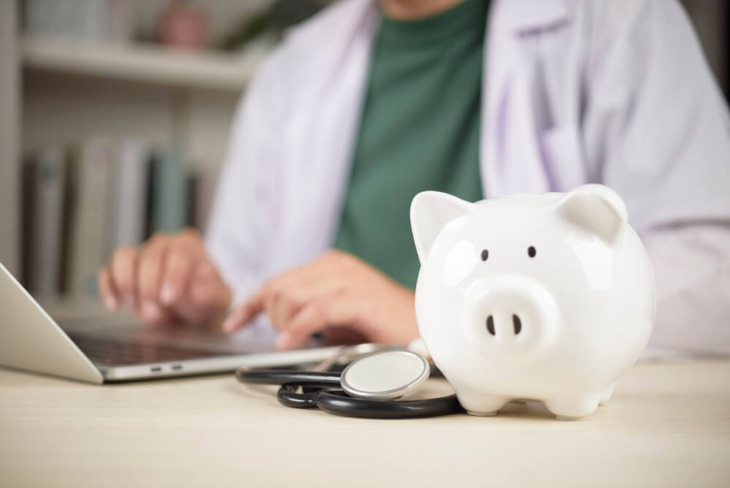 A doctor with a piggy bank. Learn more about if medicaid covers addiction rehab here.