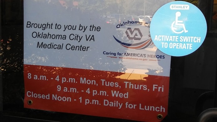 Exterior entrance showing Department of Veterans Affairs Community-Based Outpatient Clinic signage with address and hours of operation