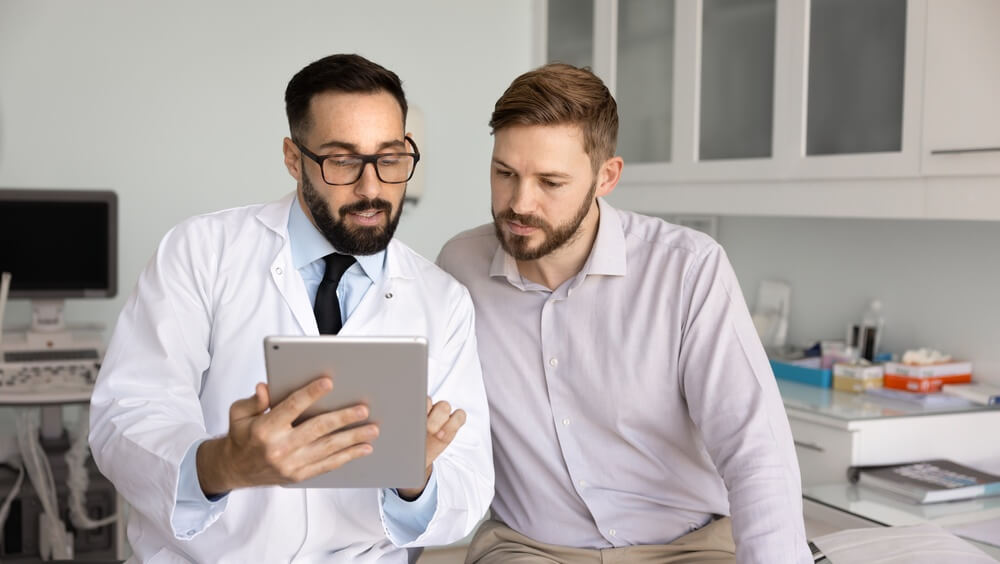 A man speaking with a doctor during an appointment