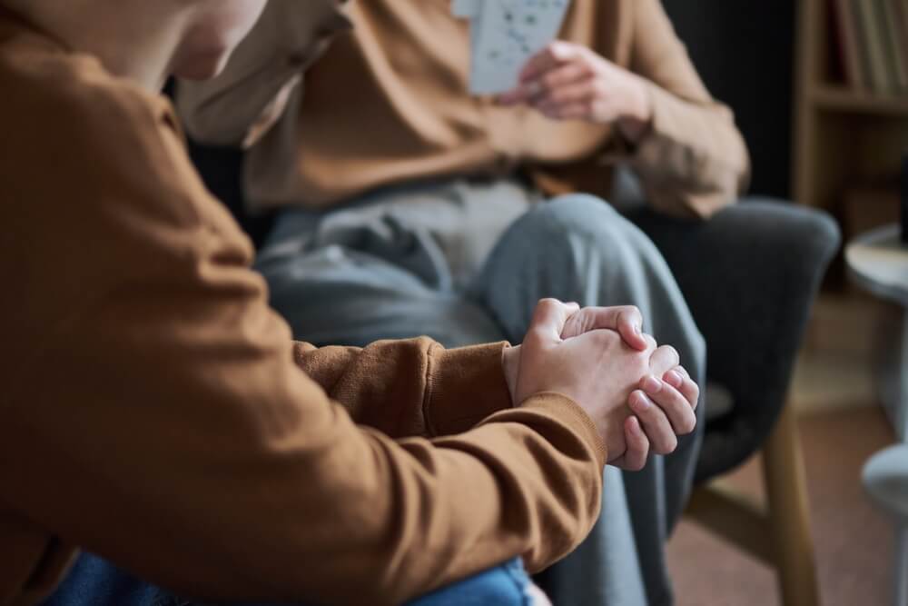 A man sits during a support group meeting. Learn more about how to get sober here.