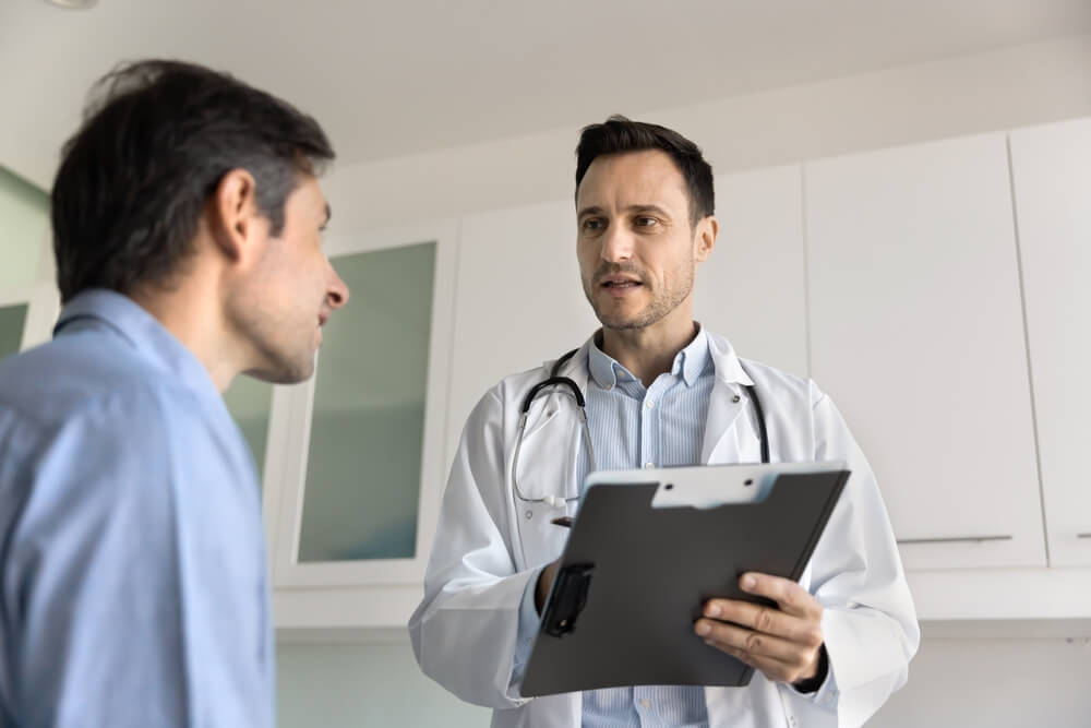 A doctor speaking with a patient. Learn more about the dangers of synthetic marijuana here