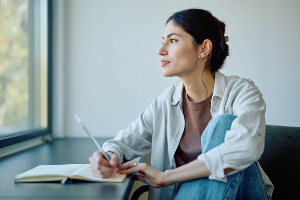 A woman writing a journal. 