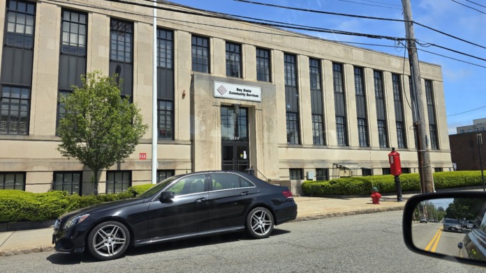 Exterior view of facility with parking, fire hydrant, and landscaping in clear daylight