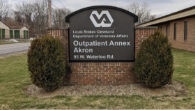 Exterior sign for Louis Stokes Cleveland Department of Veterans Affairs Outpatient Annex Akron at 95 W. Waterloo Rd with landscaping