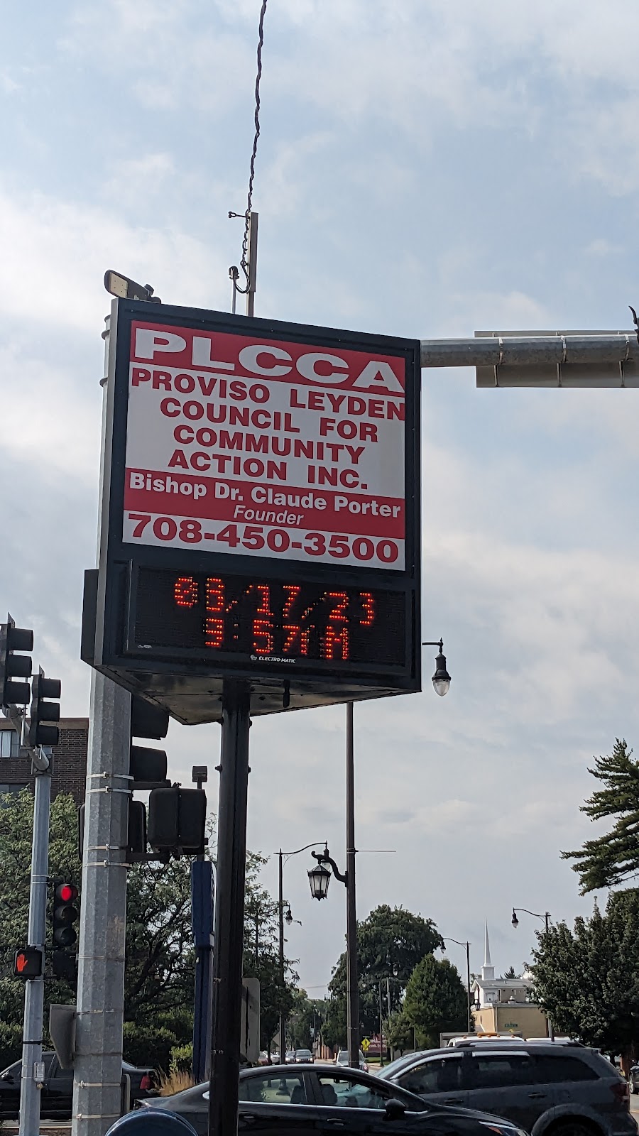 Exterior view of PLCCA facility sign displaying organization name, founder information, and contact phone number