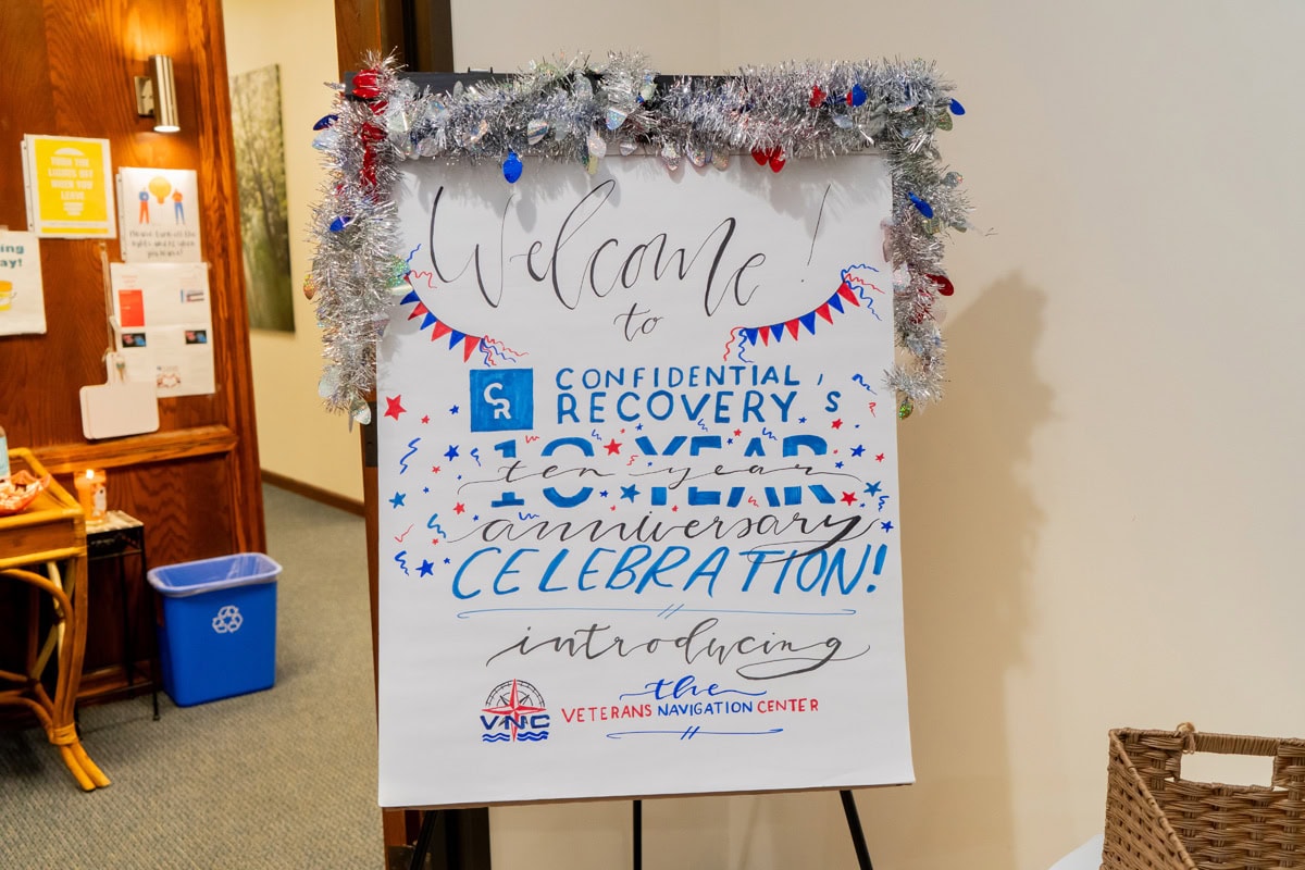 Interior lobby area featuring Confidential Recovery welcome sign with decorative tinsel and facility branding displayed