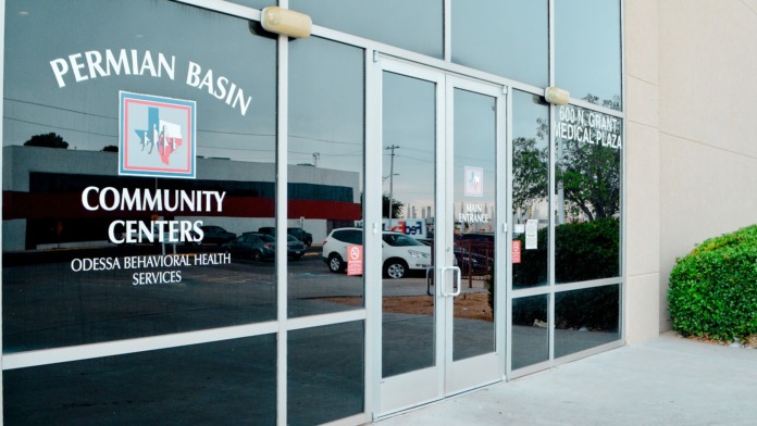 Exterior storefront showing Permian Basin Community Centers entrance with glass doors and signage